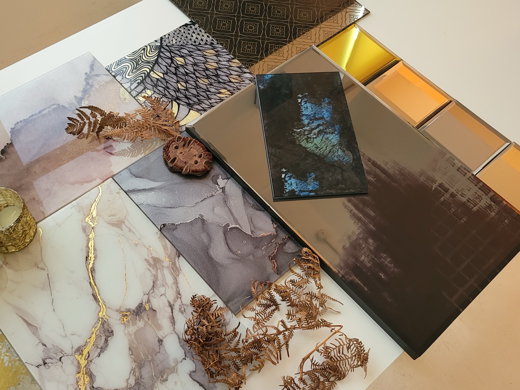 A moodboard of mirrored glass, marble, gold leaf and dried botanicals